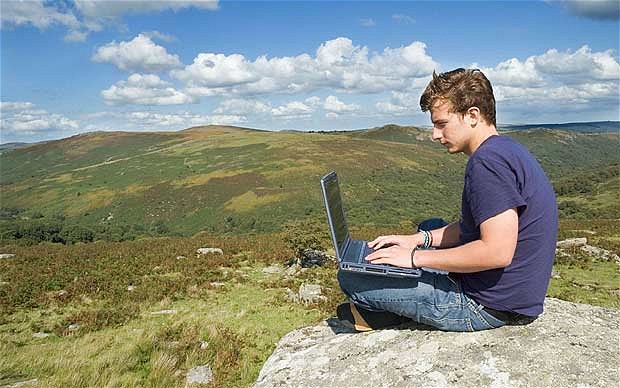 Laptop user on mountain